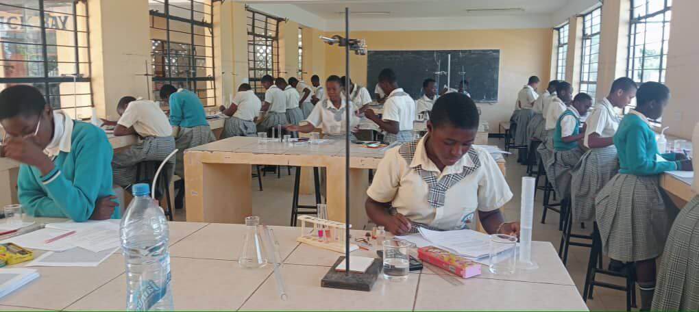 Holy Family Girls School students in modern classroom engaged in learning activities in Mwanza, Tanzania